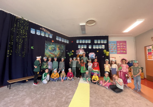 Zdjęcie grupy 'Elfy" z wychowawcą na tle dekoracji.