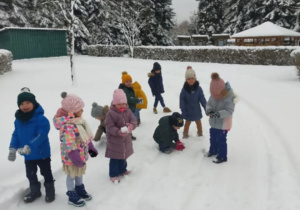 dzieci rzucają się śnieżkami