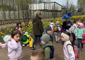 Dzieci wraz z przewodnikiem zwiedzają park.